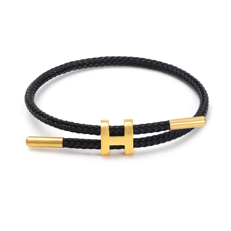 Elegant Flätat Armband med Guld H Spänne